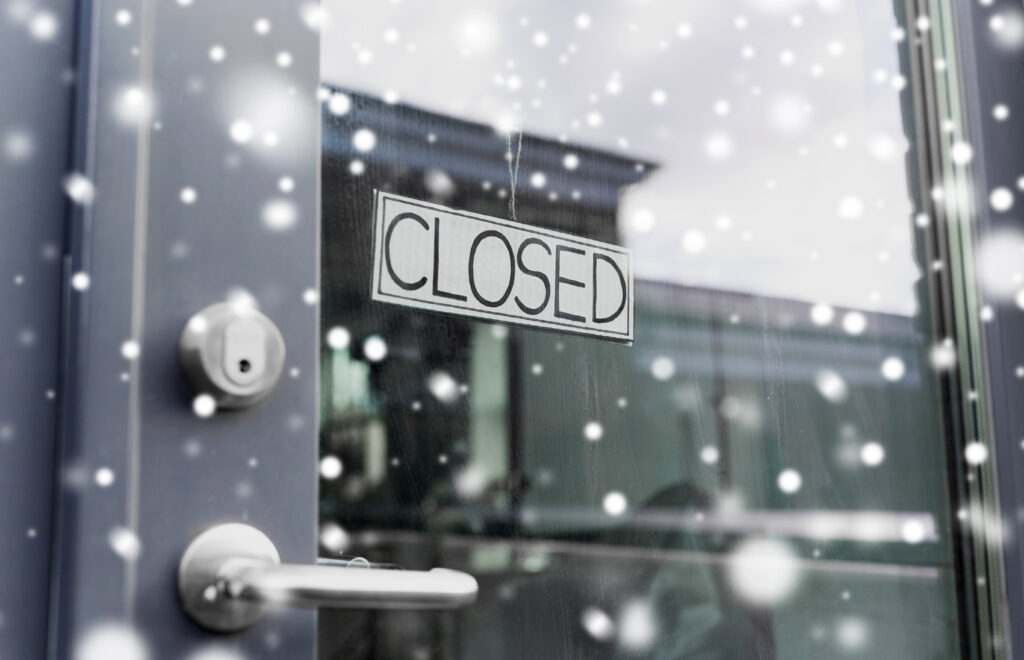 small business, pandemic and service concept - glass door of closed shop or office in winter over snow
By Syda Productions